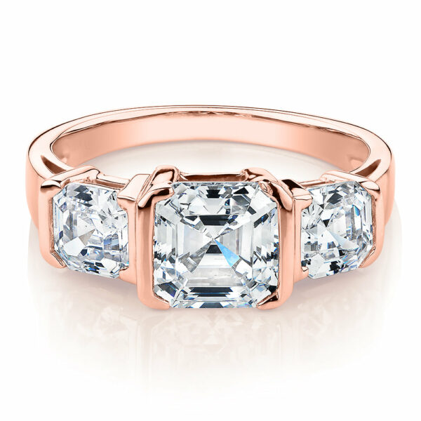 Three stone ring with 3.38 carats* of diamond simulants in 10 carat rose gold
