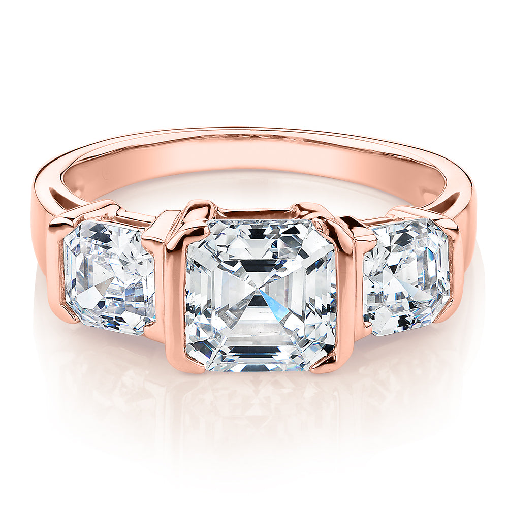 Three stone ring with 3.38 carats* of diamond simulants in 10 carat rose gold