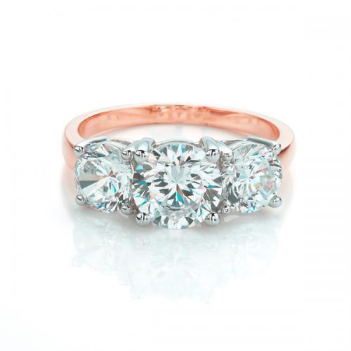 Three stone ring with 3 carats* of diamond simulants in 10 carat rose and white gold