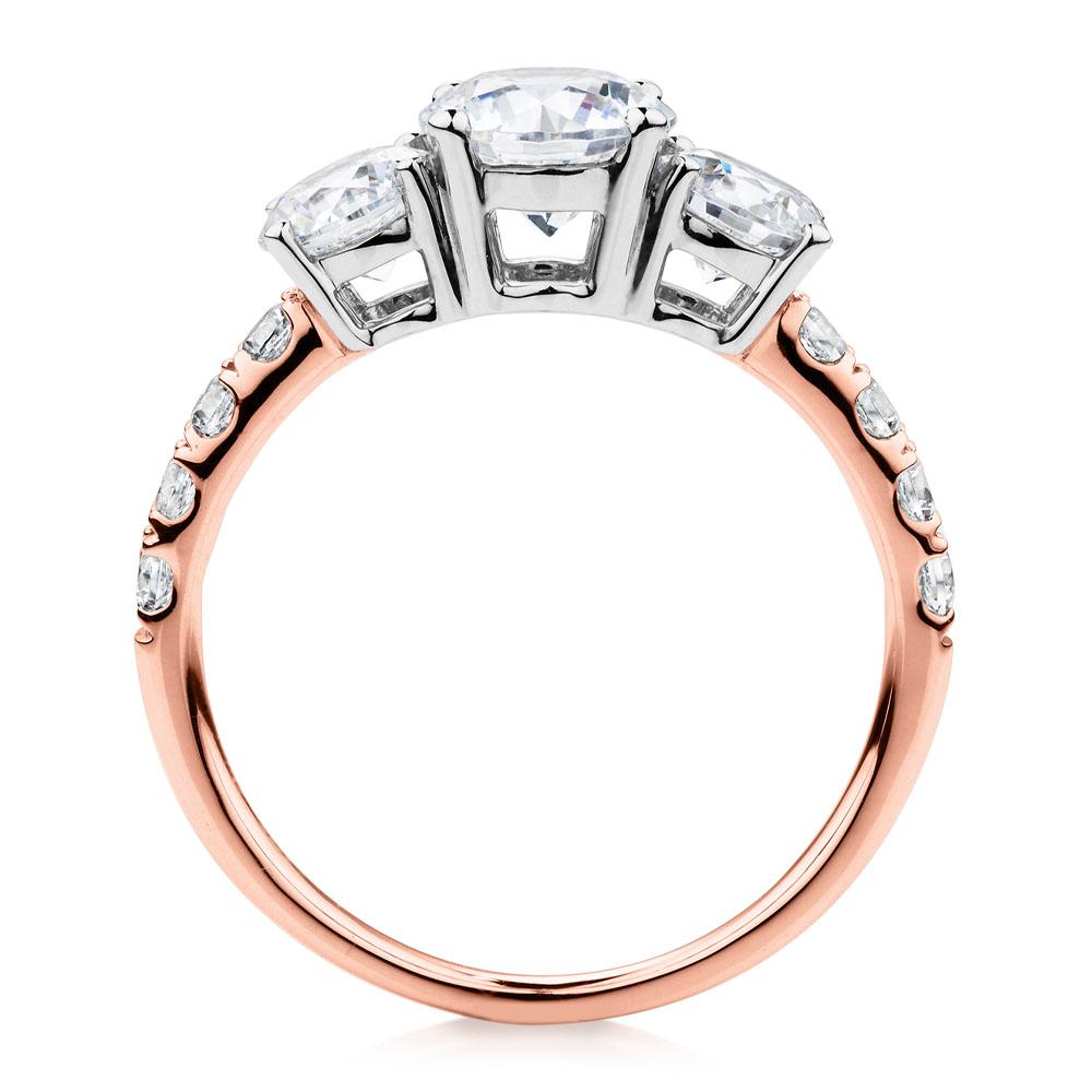 Three stone ring with 2.19 carats* of diamond simulants in 10 carat rose and white gold - Image 3