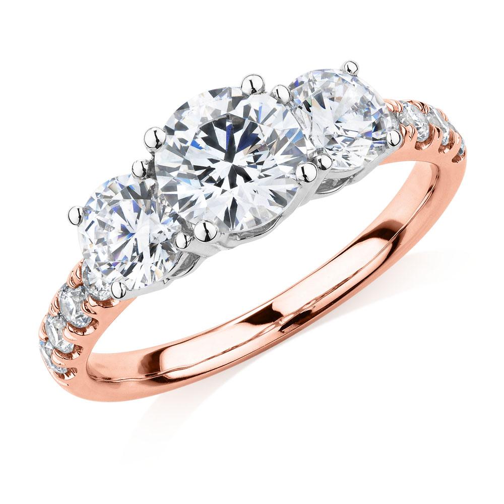 Three stone ring with 2.19 carats* of diamond simulants in 10 carat rose and white gold - Image 4